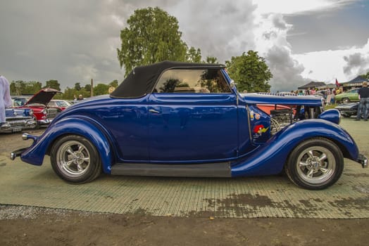 The image is shot at Fredriksten fortress in Halden, Norway during the annual classic car event.