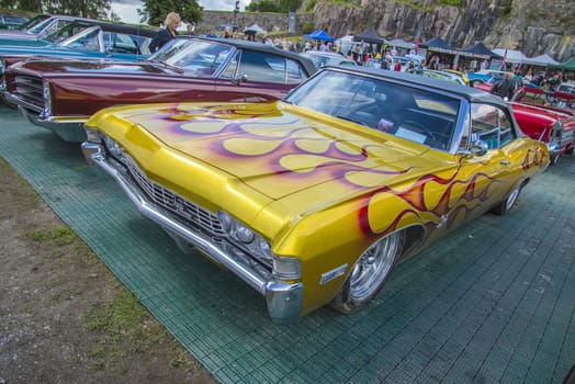 The image is shot at Fredriksten fortress in Halden, Norway during the annual classic car event.