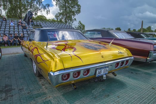 The image is shot at Fredriksten fortress in Halden, Norway during the annual classic car event.