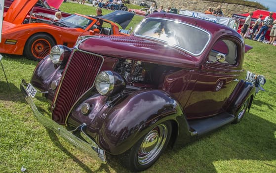 The image is shot at Fredriksten fortress in Halden, Norway during the annual classic car event.