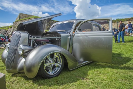 The image is shot at Fredriksten fortress in Halden, Norway during the annual classic car event.