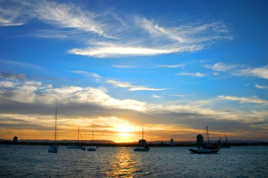 Setting sun with a giant sky over yachts.