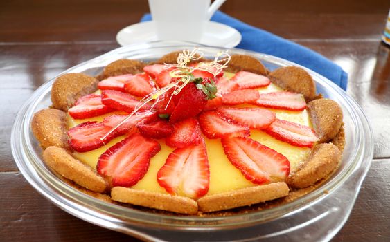Lovely strawberry custard biscuit tart with toffee garnish ready to serve.