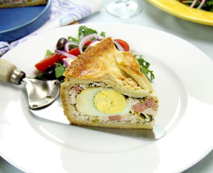 Delicious slice of baked ham and egg pie ready to serve.