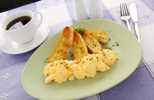 Delicious and healthy breakfast of scrambled eggs with toast.
