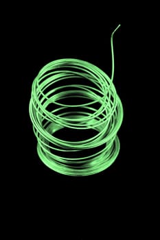 Roll of fuse wire with a green tint.