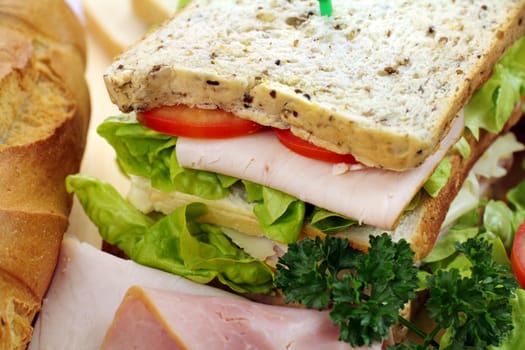 Delicious ham and salad sandwich with ingredients ready to serve.