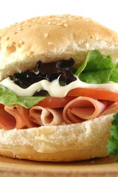 Freshly prepared ham and salad roll with mayo ready to serve