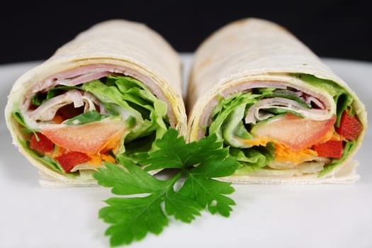 Delicious cut ham and salad wrap ready to serve.