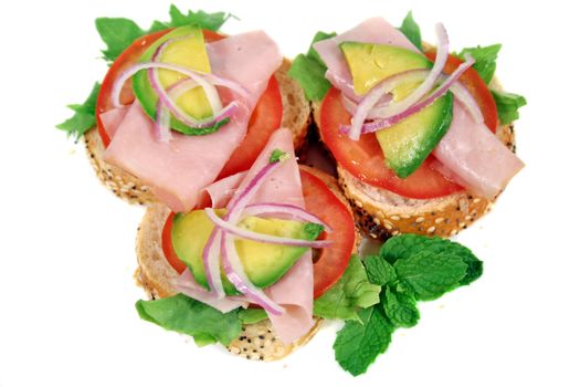 Delicious ham, tomato and avocado bites ready to serve.