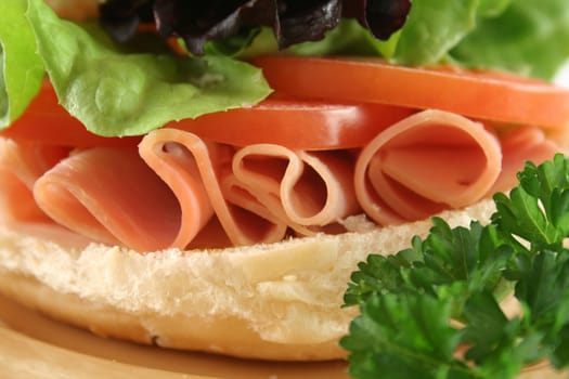 Freshly prepared ham and salad roll ready to serve.