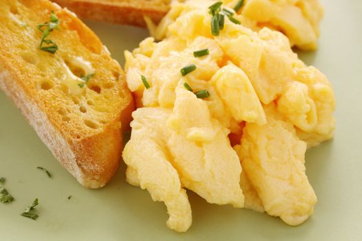 Delicious and healthy breakfast of scrambled eggs with toast.