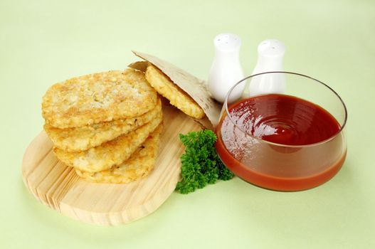 Hash browns with ketchup and parsley ready to serve.