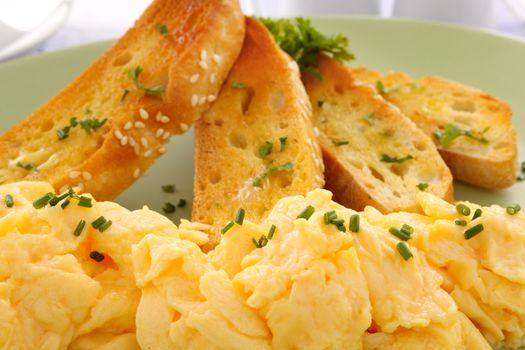 Delicious and healthy breakfast of scrambled eggs with Turkish bread toast.
