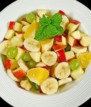 Healthy homemade fruit salad with mint ready to serve.