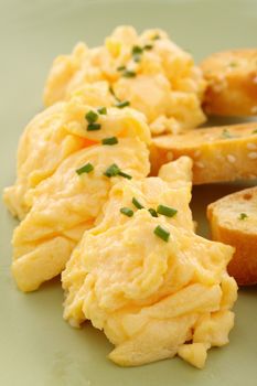 Delicious and healthy breakfast of scrambled eggs with toast.