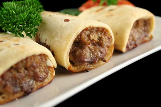 Delicious fresh baked homestyle sausage rolls ready to serve.