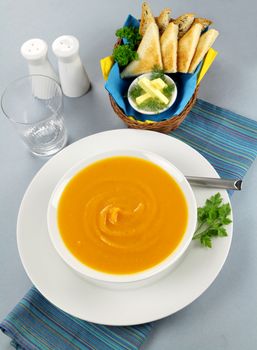 Delicious pumkin soup with a selection of toasts with butter.