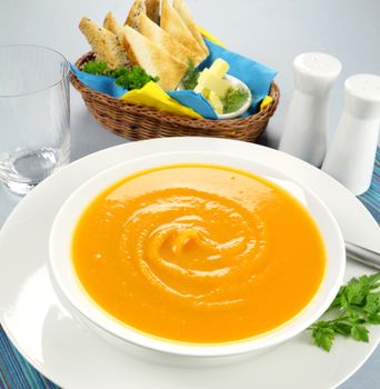 Delicious pumkin soup with a selection of toasts with butter.