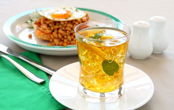Delightful mint and lemon iced tea with baked beans for breakfast.