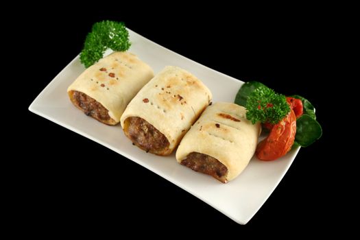 Delicious fresh baked homestyle sausage rolls ready to serve.