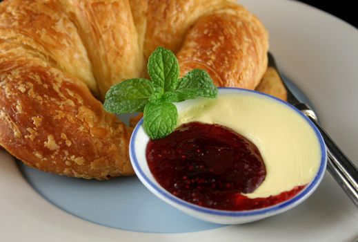 Raspberry jam and butter arrangement in a dish.