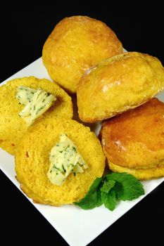 Fresh homemade pumpkin scones herb butter ready to serve.