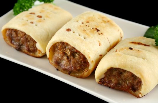 Delicious fresh baked homestyle sausage rolls ready to serve.