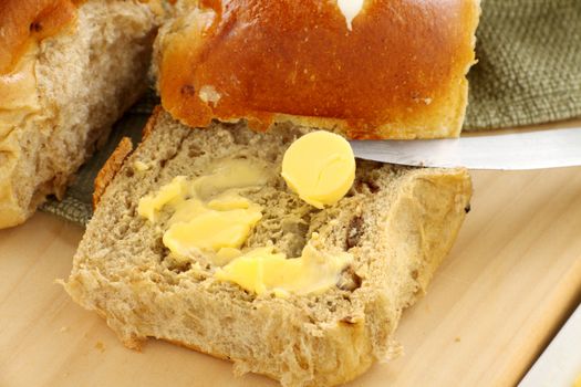 Hot cross buns with butter ready to serve for Easter.
