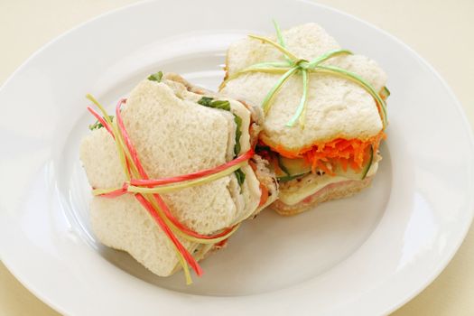 Healthy kids sandwiches cut in the shape of a star and tied up.