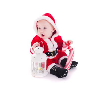Little Santa boy with lantern and staff isolated on white background