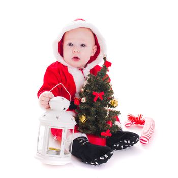 Little Santa boy with lantern and christmas tree isolated on white background