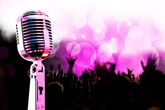 Live music background.Vintage microphone and public