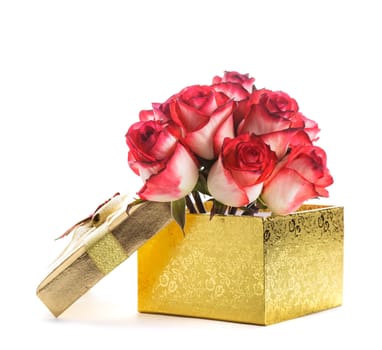 Golden gift box and bouquet of roses isolated on white