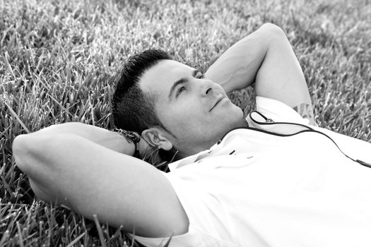 Man portrait lying on the grass.