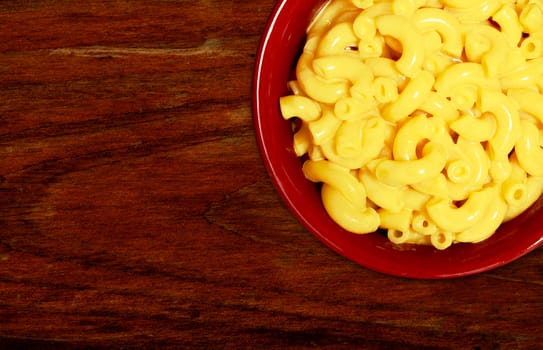 macaroni and cheese on dark wood background