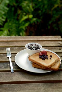 breakfast with berries, toast and jam in summer