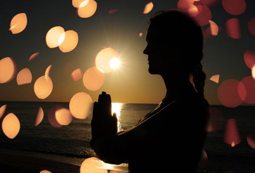 woman praying or meditating on beach