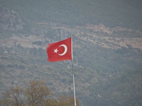 Raised the flag of Turkey develops in the mountains in Alanya