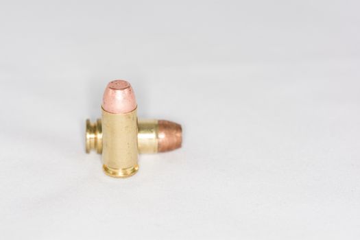Two hand gun bullets on white background with detail