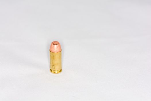 Hand gun bullet on white background with detail