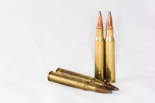 A few rifle bullets on white background with details