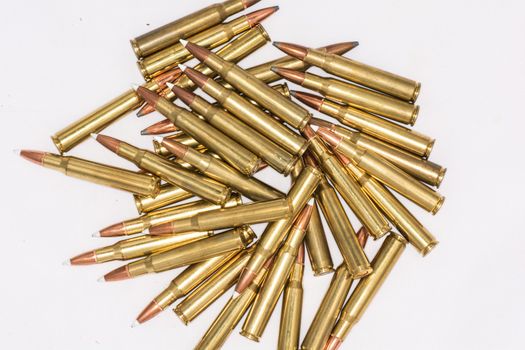Pile of loaded rifle bullets isolated with white background with details