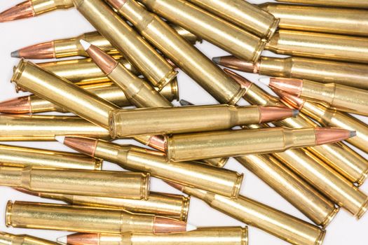 Pile of loaded rifle bullets isolated with white background with details