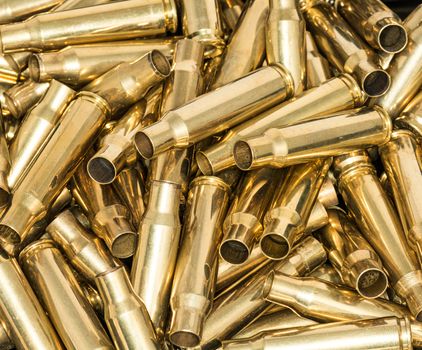 Abstract of pile of empty bullet shells with details