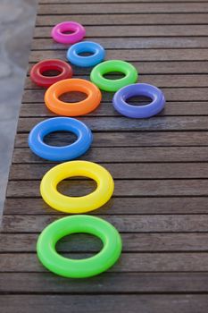 Close up of a row of childrens stacking rings in bright colors. Focus on the middle ring