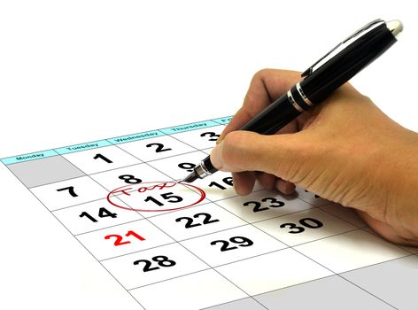 Hand Circling Tax Date on a Calender with Pen
