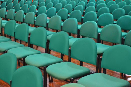 Rows of Green Chairs in a Seminar Hall