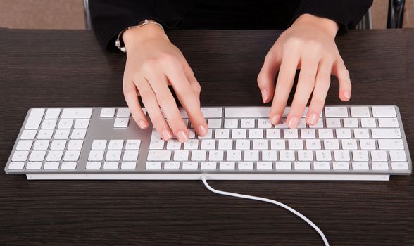 Businesswoman typing at computer in office