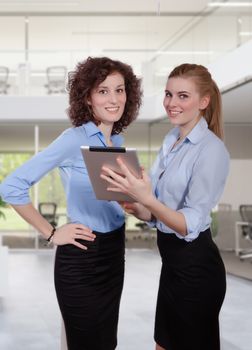 Business womans meeting in office with electronic tablet